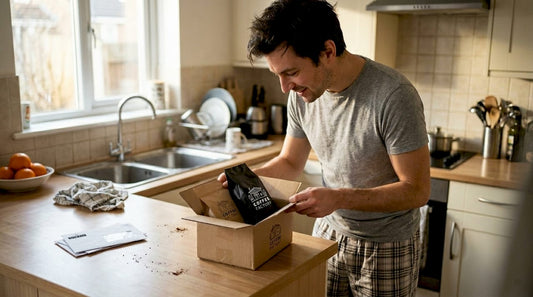 Man opens fresh coffee gift box at kitchen