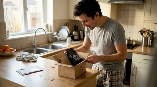 Man opens fresh coffee gift box at kitchen